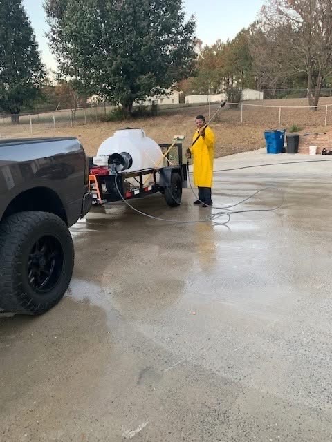 Pressure washing trailer and tank rig on a driveway