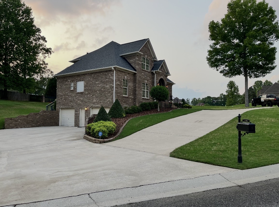 Cleaned brick home with a fresh driveway